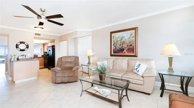 a bedroom with a large bed and chandelier