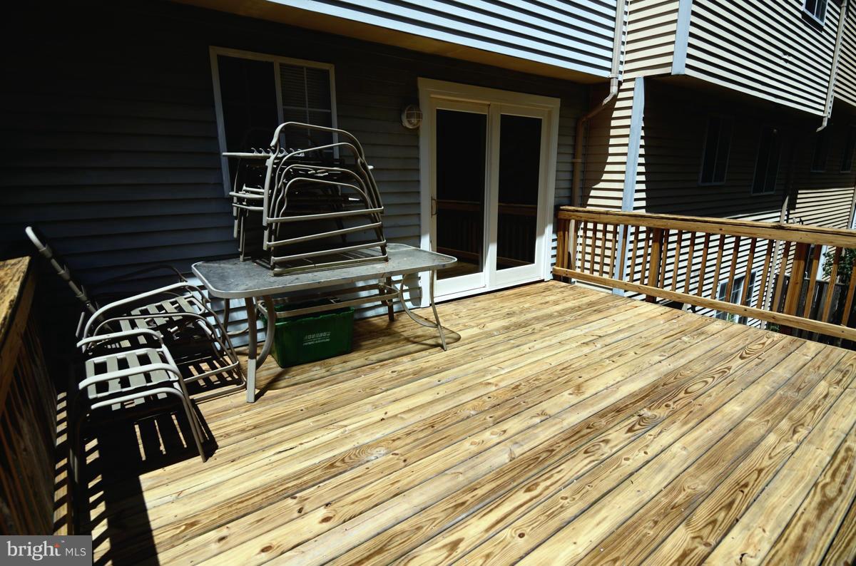 10334 Apple Ridge Road Gaithersburg, MD 20886 - Photo 16 of 18 a view of a balcony with a door and wooden floor