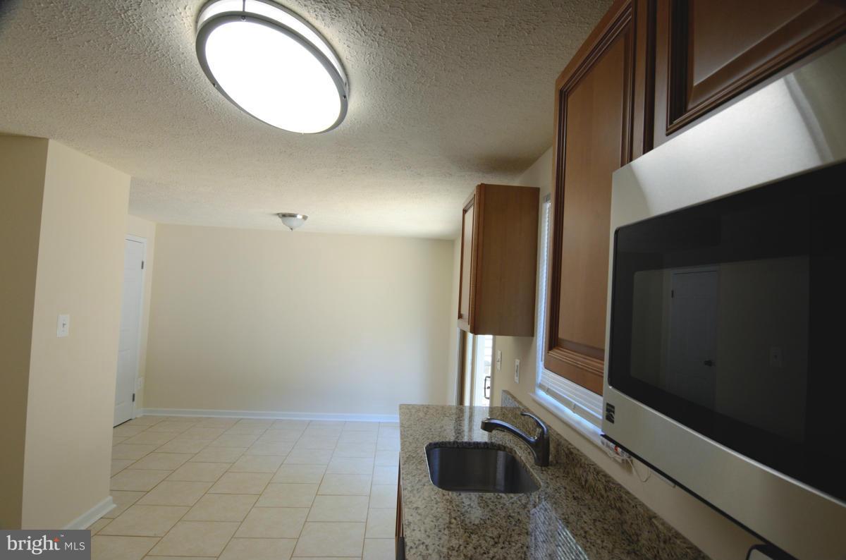 10334 Apple Ridge Road Gaithersburg, MD 20886 - Photo 3 of 18 a view of a hallway with washer and dryer