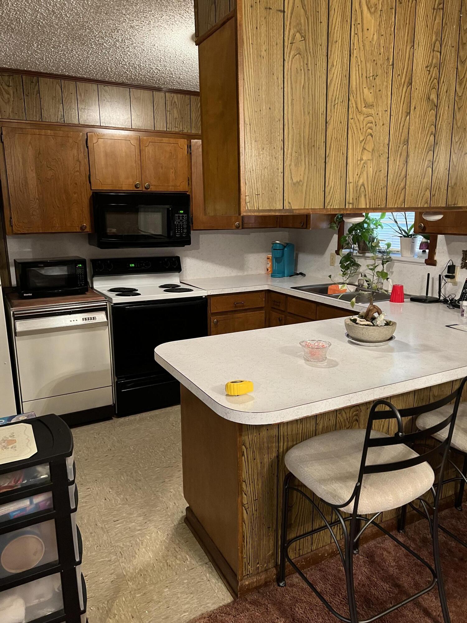 3693 Airport Road Crestview, FL 32539 - Photo 8 of 18 a kitchen with a stove a sink and a microwave