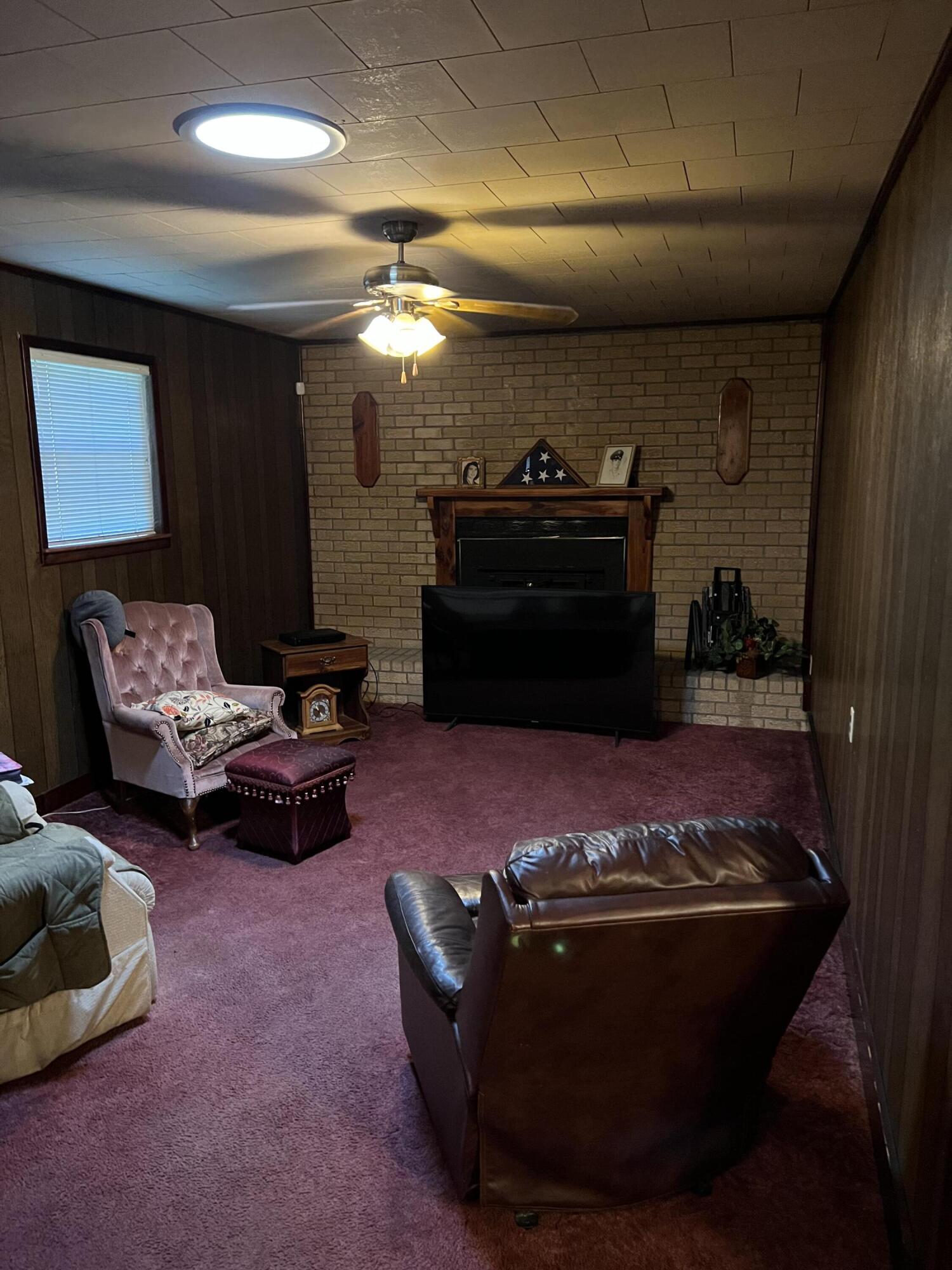 3693 Airport Road Crestview, FL 32539 - Photo 9 of 18 a living room with furniture and a fireplace