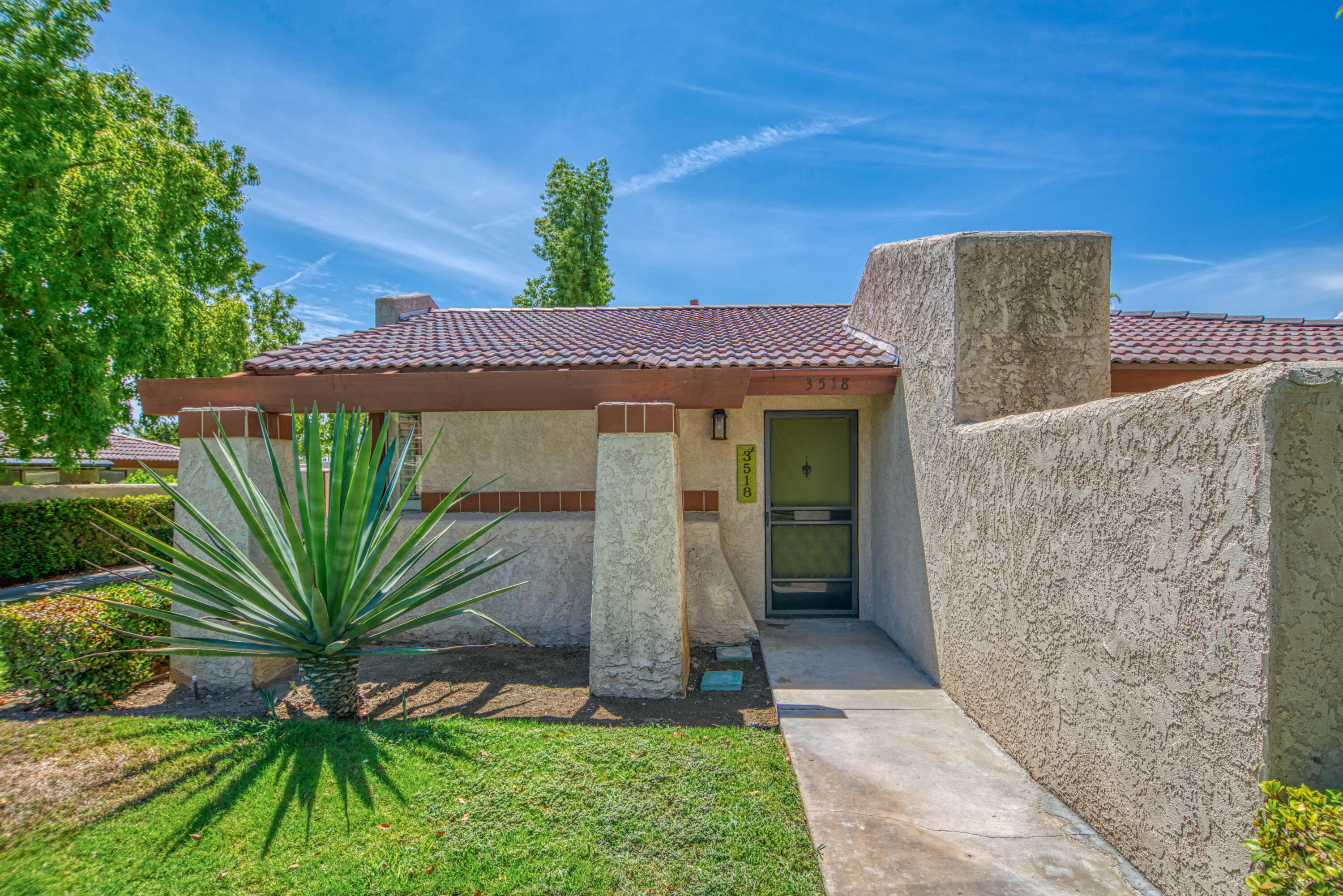3518 Ridgeview Circle South Palm Springs, CA 92264 - Photo 12 of 32 a front view of a house with a yard