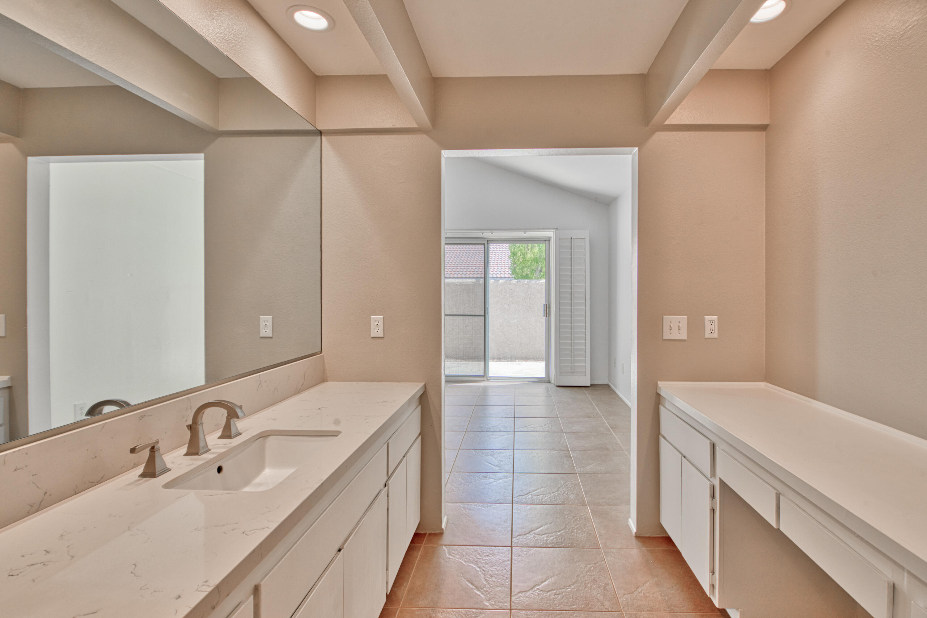 3518 Ridgeview Circle South Palm Springs, CA 92264 - Photo 30 of 32 a spacious bathroom with a double vanity sink and a mirror
