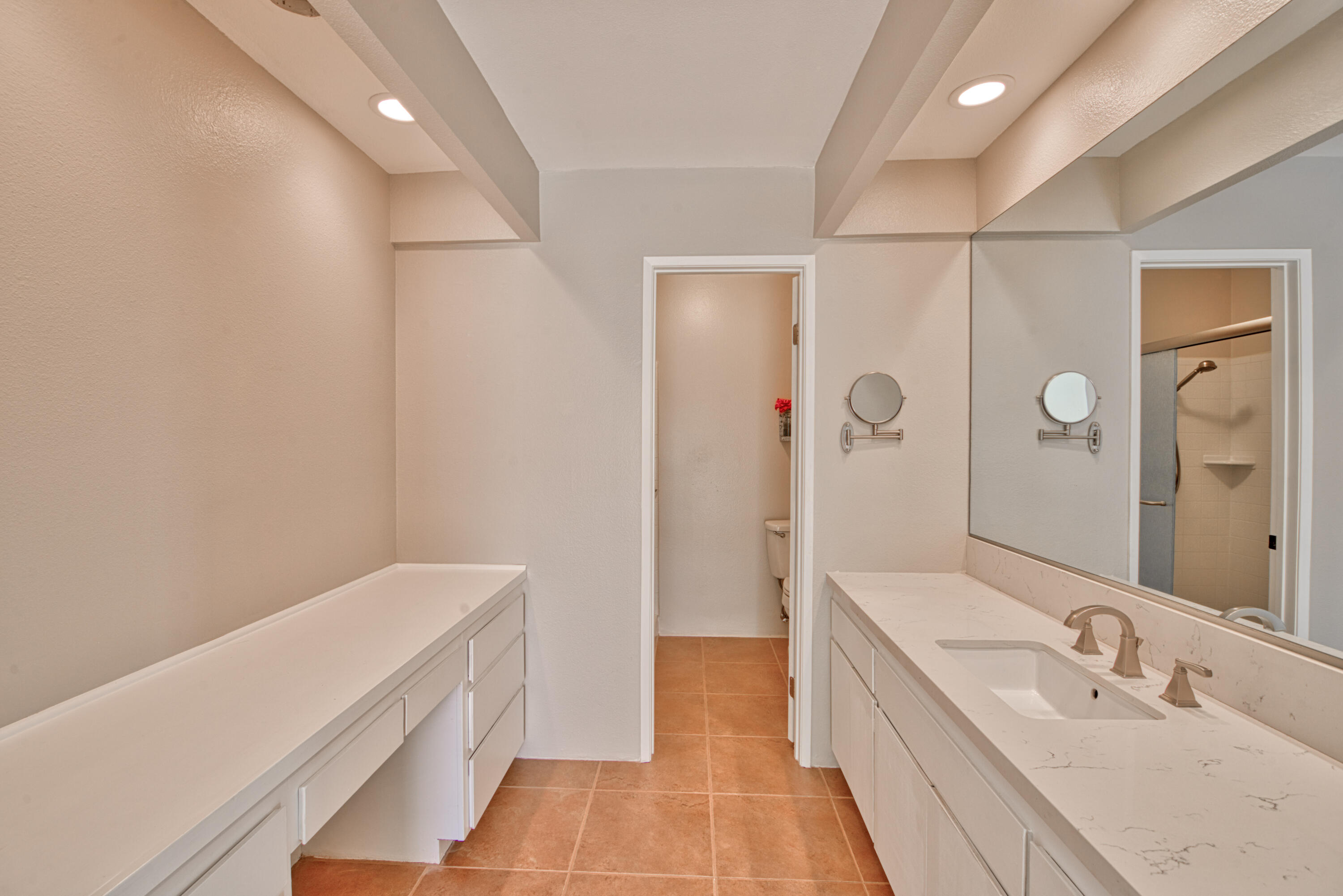 3518 Ridgeview Circle South Palm Springs, CA 92264 - Photo 31 of 32 a spacious bathroom with a double vanity sink and a mirror