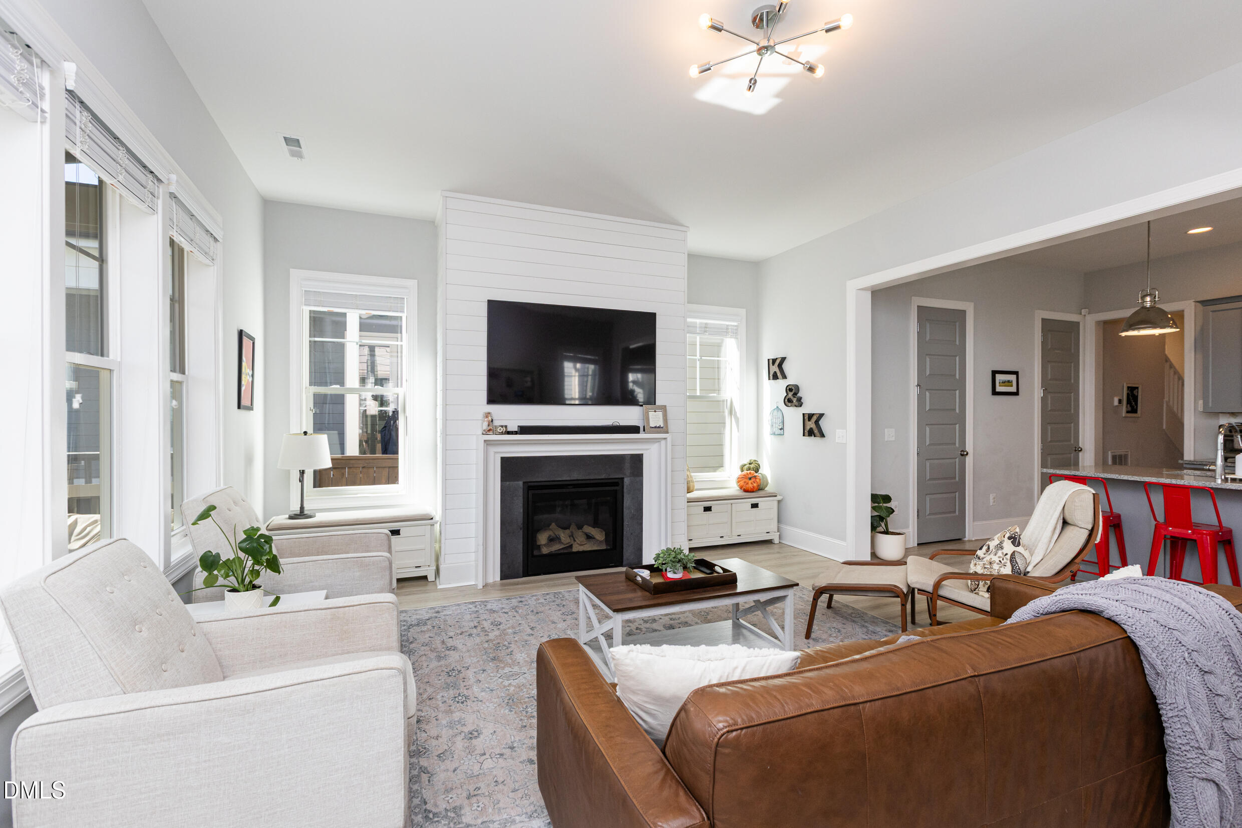 1103 Tannin Drive Durham, NC 27713 - Photo 14 of 28 a living room with furniture a fireplace and a flat screen tv
