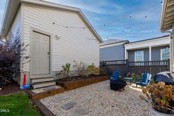 a backyard of a house with outdoor seating