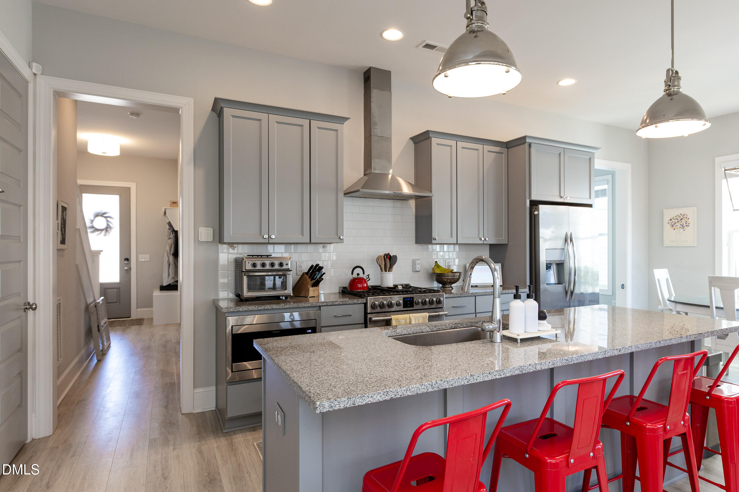 1103 Tannin Drive Durham, NC 27713 - Photo 8 of 28 a kitchen with stainless steel appliances granite countertop a sink refrigerator and cabinets