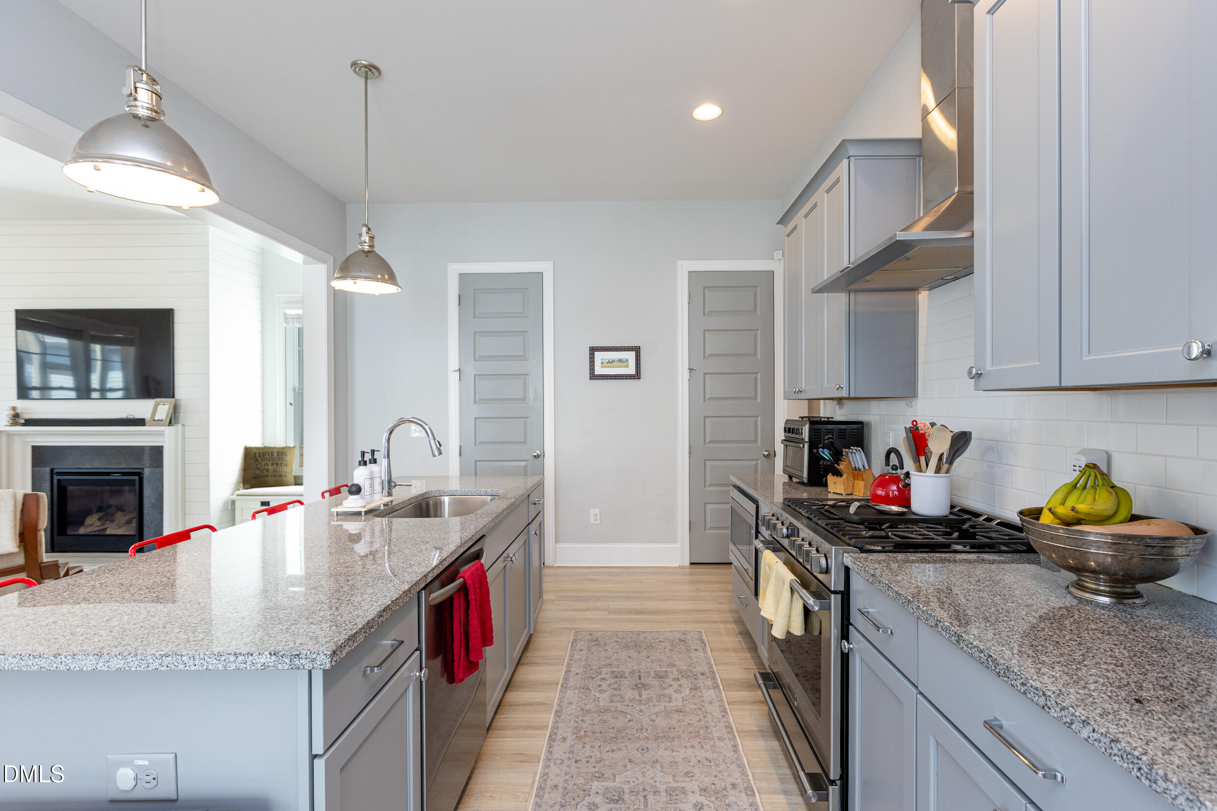 1103 Tannin Drive Durham, NC 27713 - Photo 10 of 28 a kitchen with granite countertop a sink a counter and cabinets