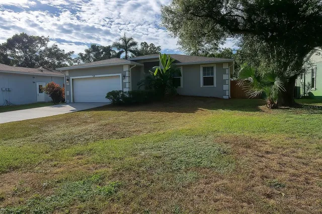 a view of a house with a yard and garage