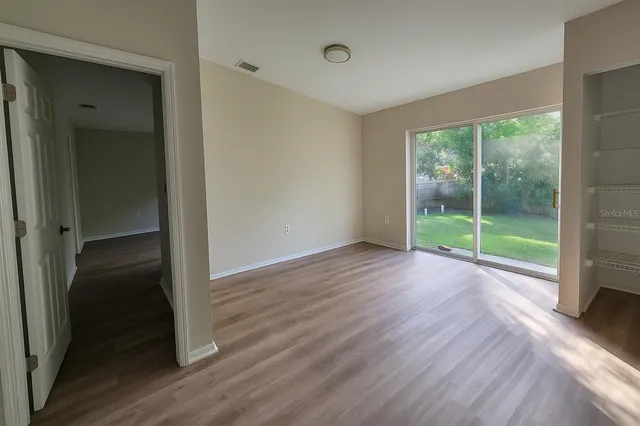 wooden floor in an empty room with a window