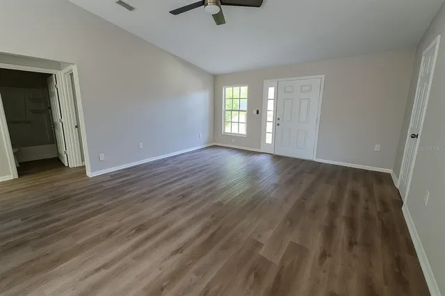 wooden floor in an empty room with a window