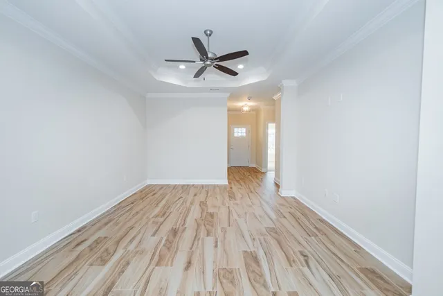 a view of empty room with wooden floor