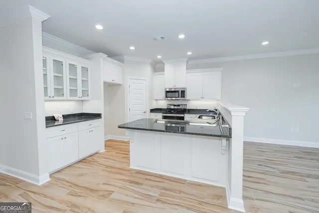 a kitchen with stainless steel appliances granite countertop a stove and a sink