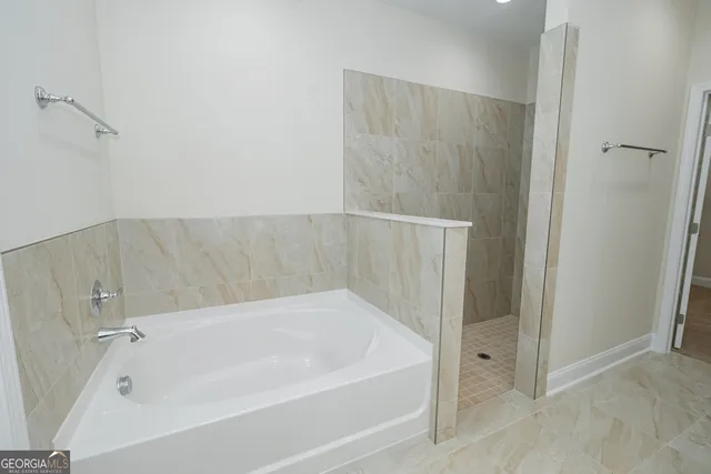 a bathroom with a tub and shower