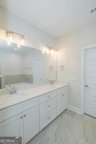 a bathroom with a double vanity sink and a mirror