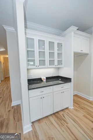 a kitchen with granite countertop a sink and cabinets