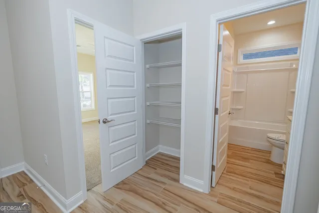 a room with wooden floor and closet