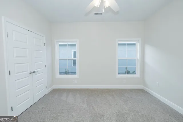 an empty room with a empty space and windows