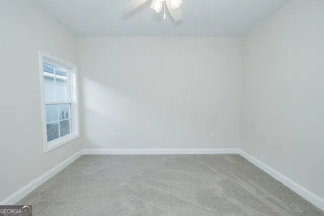 an empty room with windows and closet