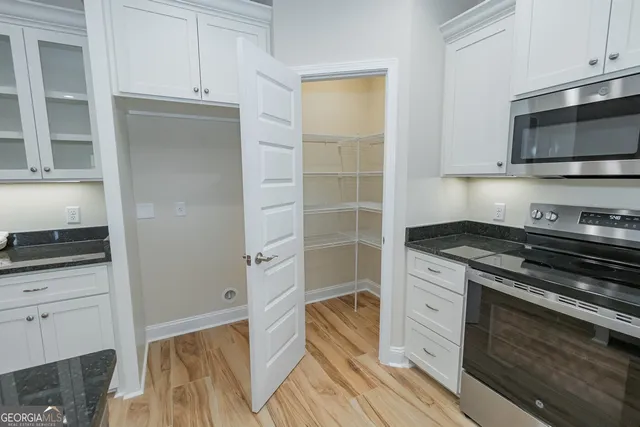 a kitchen with stainless steel appliances a stove and a microwave