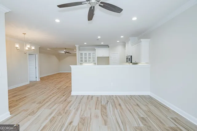 a view of a kitchen with a sink and wooden floor
