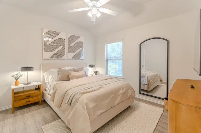 a bedroom with a bed and a window