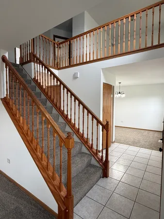 a view of staircase with lots of frames on wall and staircase