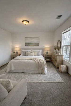 a bedroom with a bed and window