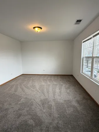 an empty room with a empty space and windows