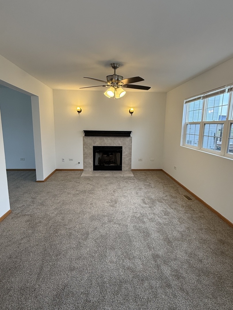 1004 Ann Street Joliet, IL 60435 - Photo 6 of 33 an empty room with windows and fireplace