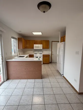 a kitchen with stainless steel appliances a refrigerator sink and cabinets