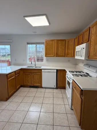 a kitchen with a stove sink and cabinets