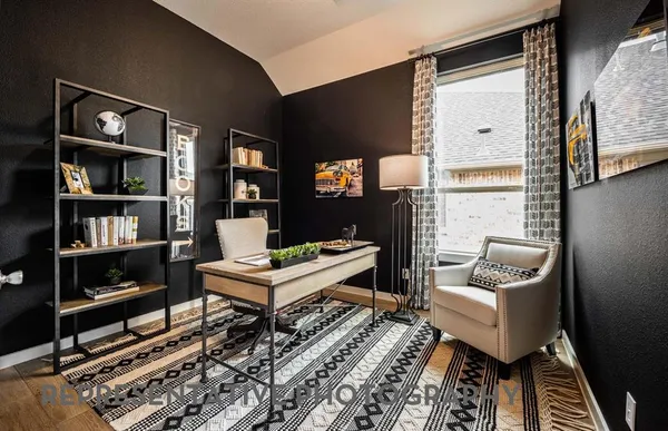 a living room with furniture and a book shelf