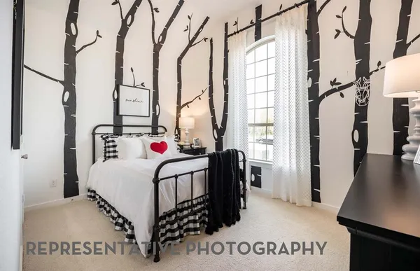 a white bed sitting in a bedroom next to a window