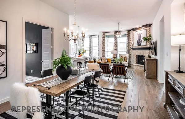 a living room with furniture a fireplace and large windows