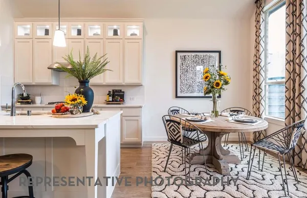 a dining room with furniture and a potted plant