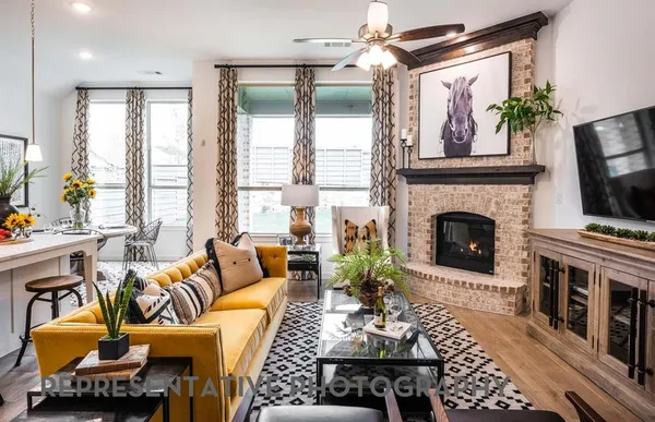 a living room with furniture fireplace and flat screen tv
