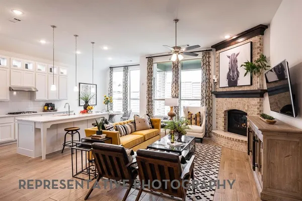 a living room with furniture a fireplace and a dining table with wooden floor