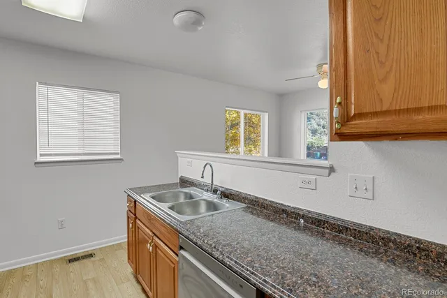 a kitchen with a sink cabinets and window