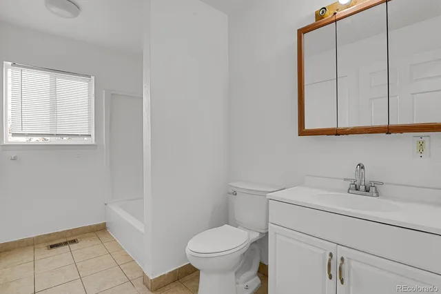 a bathroom with a sink toilet and a mirror