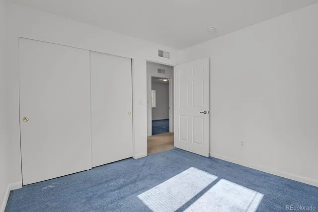 a view of an empty room and wooden floor