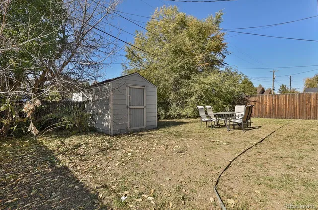 a view of a backyard with chairs