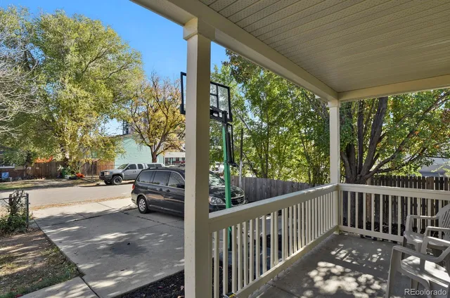 a view of a patio with a table and chairs next to a yard