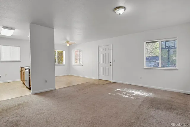 an empty room with windows and closet