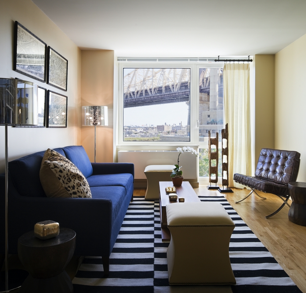 405 Main Street, Unit 9D Manhattan, NY 10044 - Photo 2 of 15 a living room with furniture and a large window