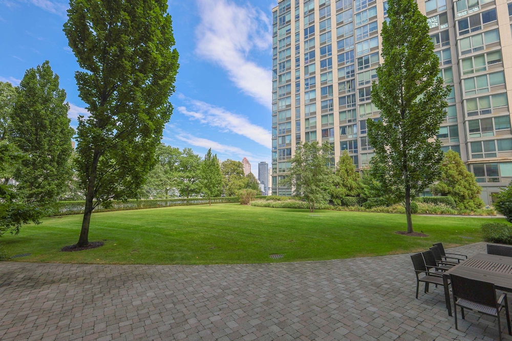 405 Main Street, Unit 9D Manhattan, NY 10044 - Photo 9 of 15 a view of a house with a yard