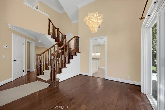 a view of entryway with wooden floor and stair