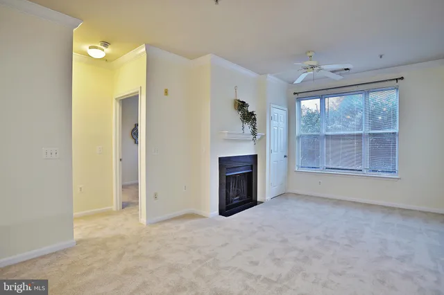 an empty room with a fireplace and windows