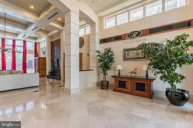 a living room with large windows and furniture