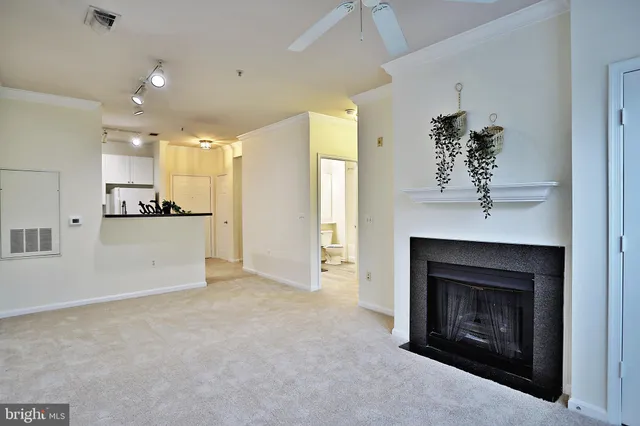 a view of a kitchen and an empty room